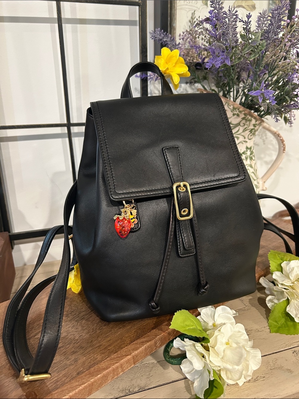 Coach Black Leather Backpack with Gold Buckle and Red Charm